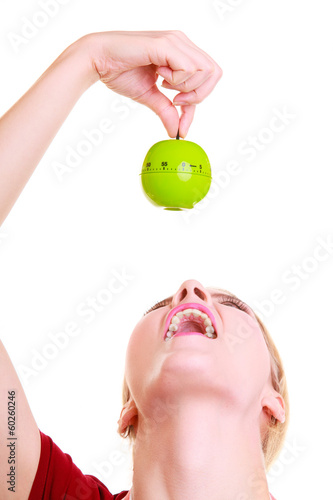 Housewife in kitchen apron trying to eat apple timer isolated photo