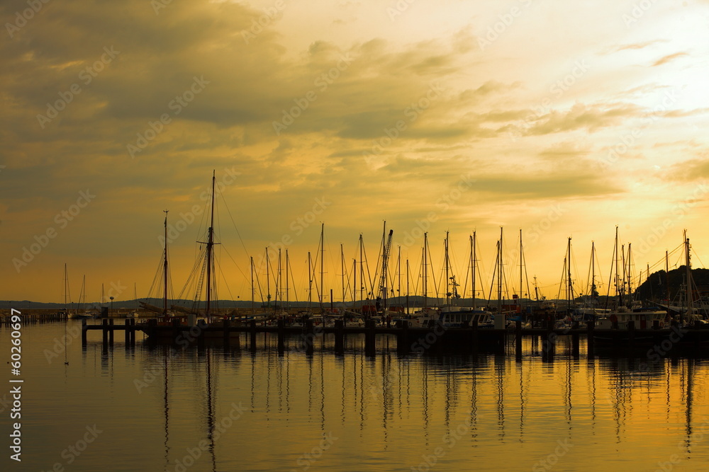 Docked yachts in marina at sunset