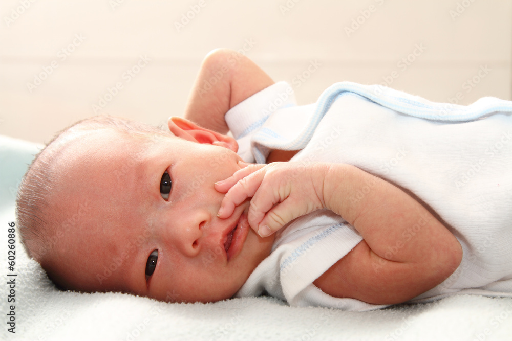 A baby boy on a bed A baby boy on a bed