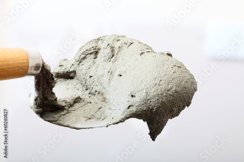 Close up bucket trowel with cement mortar