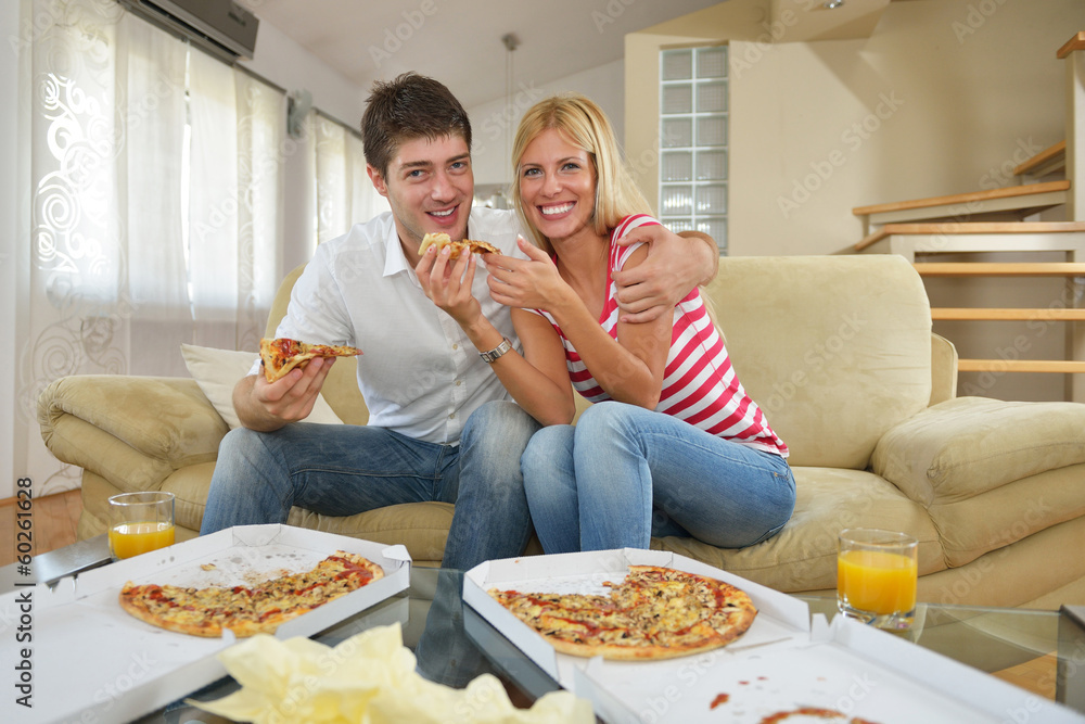 couple at home eating  pizza