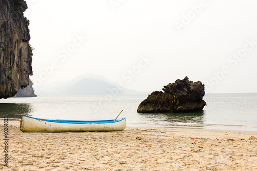 Outrigger canoe on the beach photo