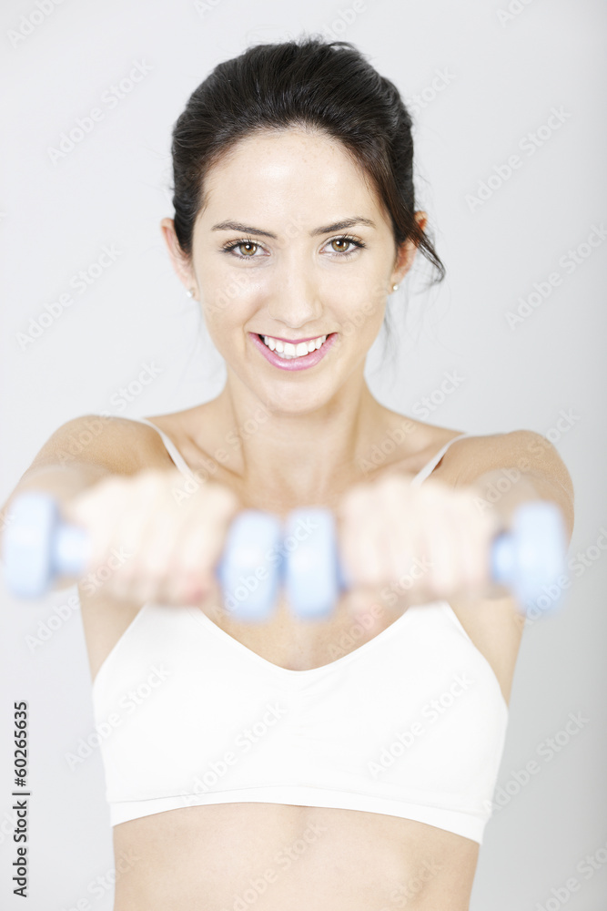 Woman using free weights Woman using free weights
