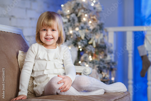Happy girl near Christmas tree.