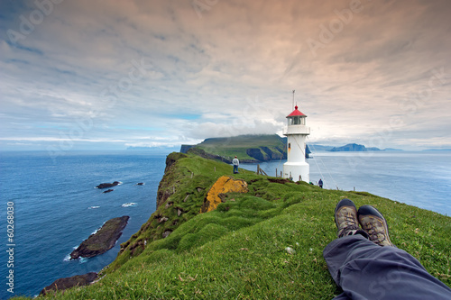 Resting after hiking at Mykines Lighthouse, Faroe Islands