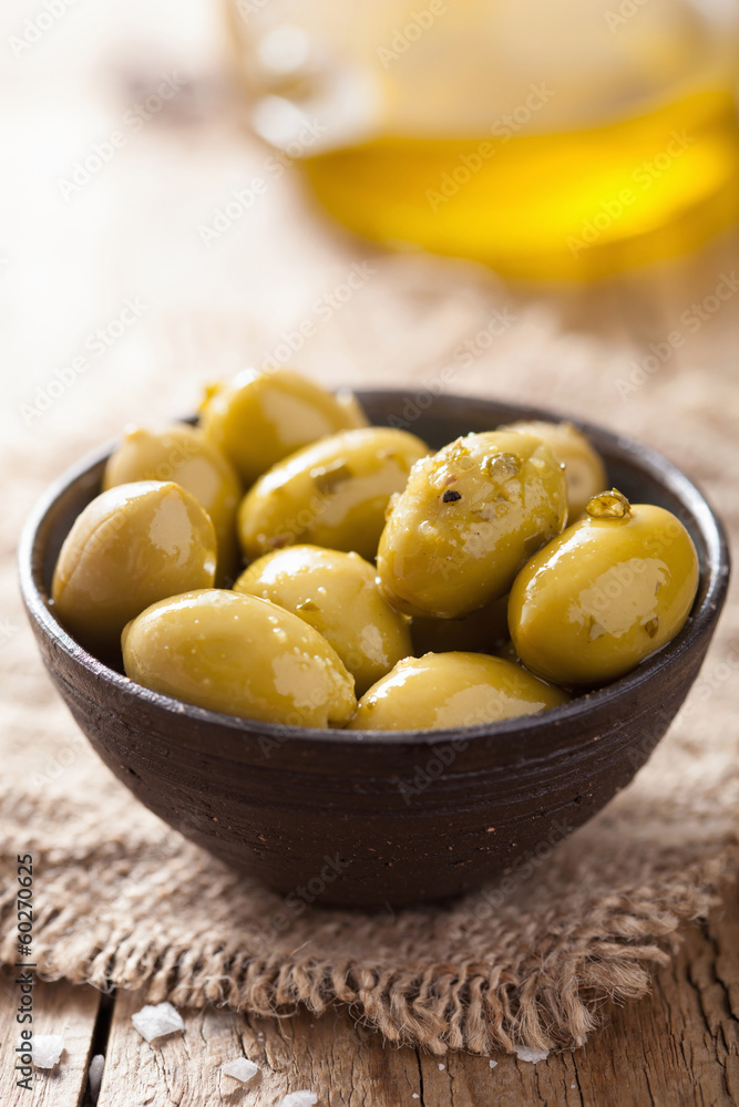 green marinated olives in bowl