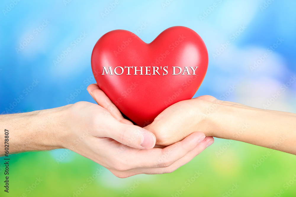 Hearts in hands on nature background Hearts in hands on nature background