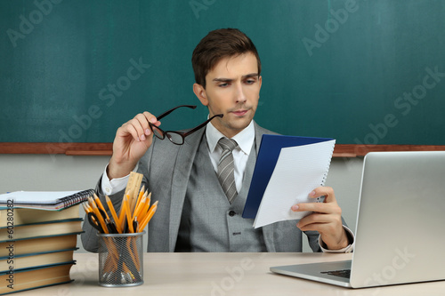 Young teacher sitting in sc...