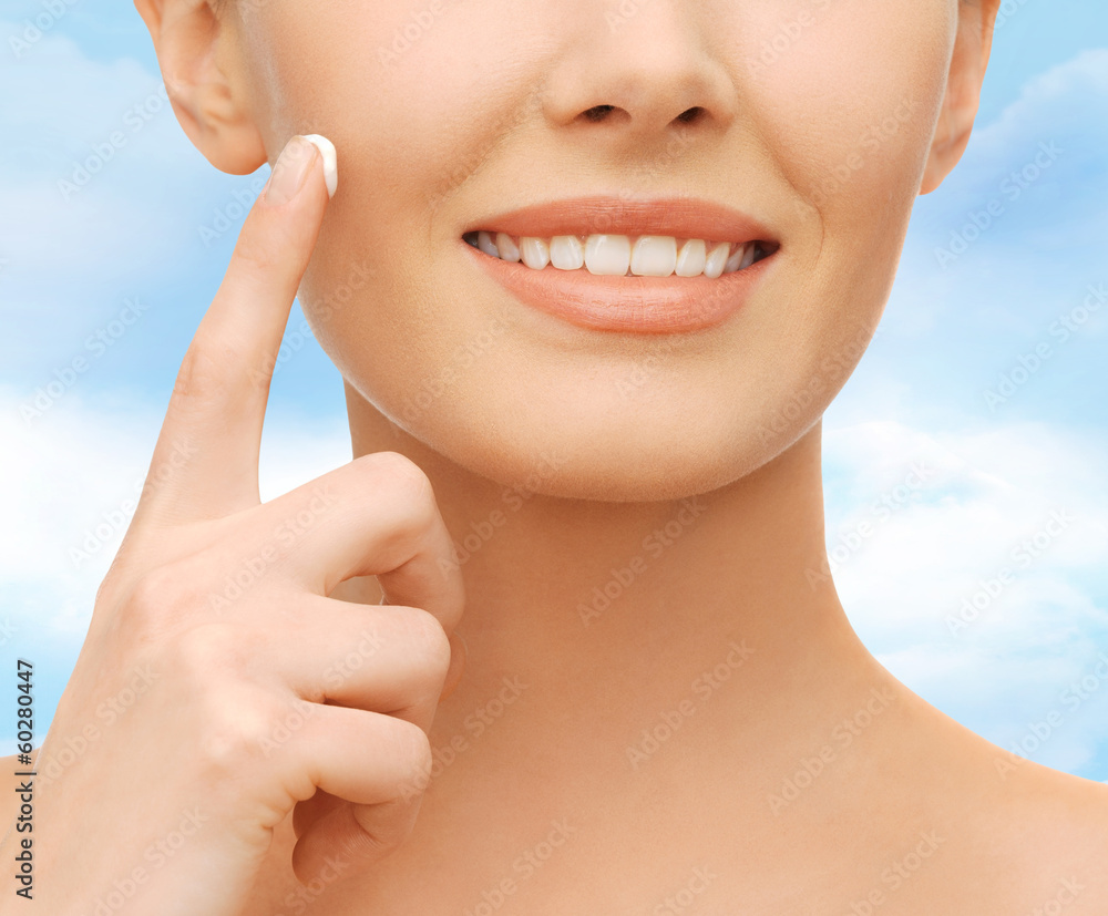 Fototapeta premium beautiful woman applying moisturizing cream