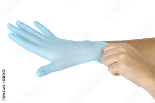 Doctor putting on protective gloves, isolated on white © Africa Studio
