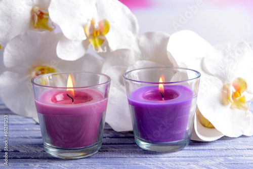 Beautiful colorful candles and  orchid flowers 