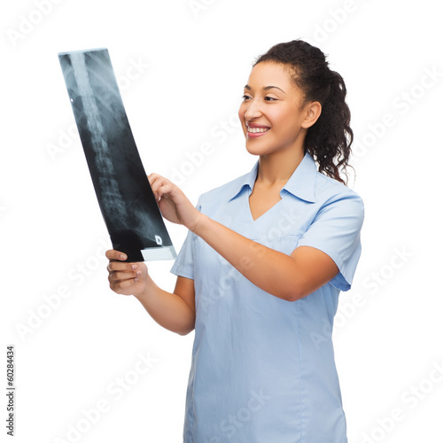 smiling female doctor or nurse looking at x-ray