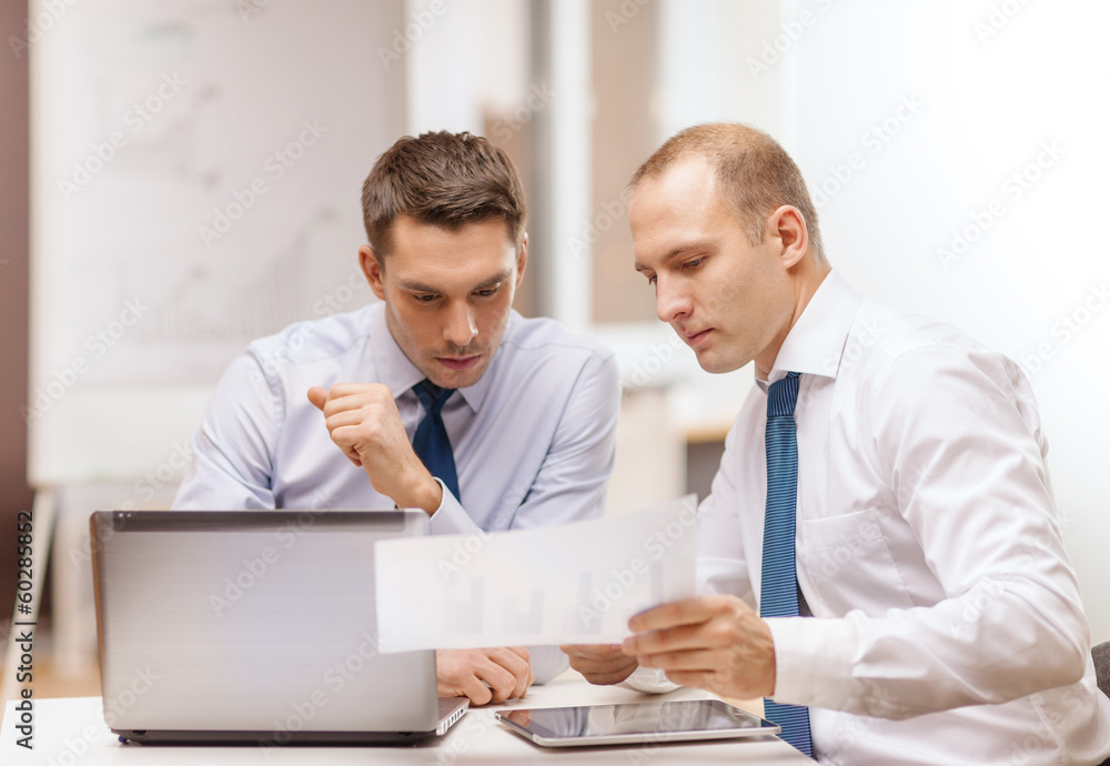 two businessmen having discussion in office two businessmen having discussion in office