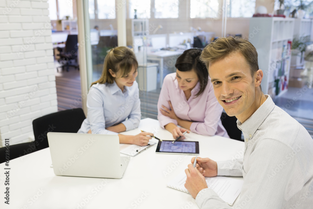 Portrait of smiling businessman during a meeting, looking camera Portrait of smiling businessman during a meeting, looking camera