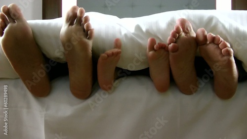 family feet under the sheet