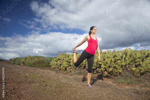 Young woman stretching before running outdoor