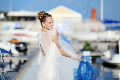 Beautiful bride posing in a harbor © MNStudio