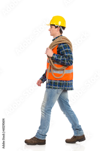 Walking construction worker with rope. © studioloco