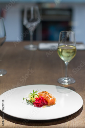 Image of tasty salmon on dish with white vine