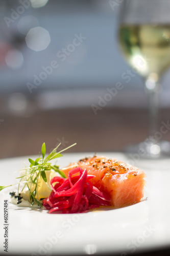 Image of tasty salmon on dish with white vine