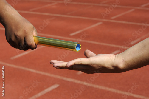 Relay-athletes hands sending action.