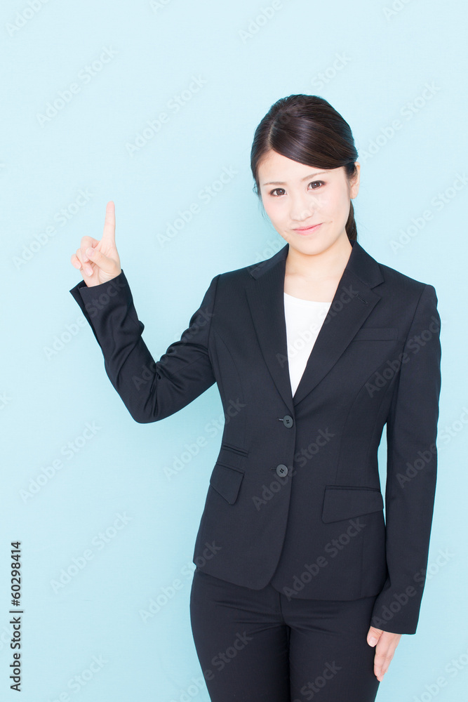 young asian businesswoman showing on blue background young asian businesswoman showing on blue background