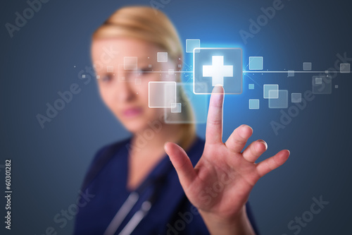 Young nurse pressing modern medical type of buttons
