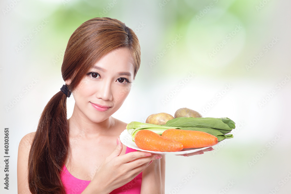 woman holding green vegetables and carrots woman holding green vegetables and carrots