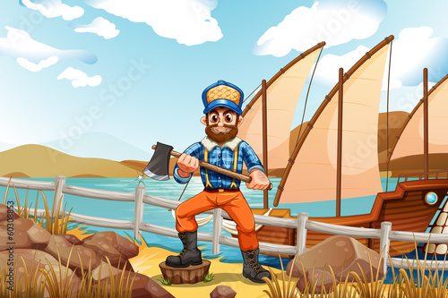 A lumberjack at the riverbank with a ship