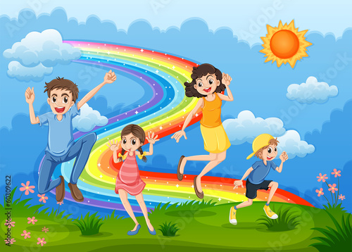 A family at the hilltop playing with the rainbow