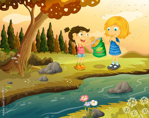 Two girls eating junkfoods at the riverbank