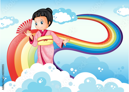 A lady wearing a kimono standing near the rainbow