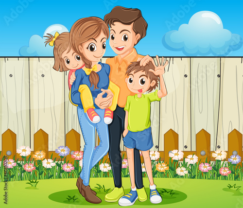 A family at the backyard with a wooden fence
