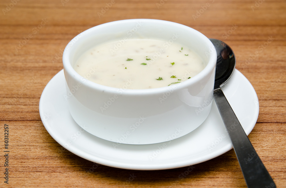 Creamy mushroom soup in a white bowl Creamy mushroom soup in a white bowl