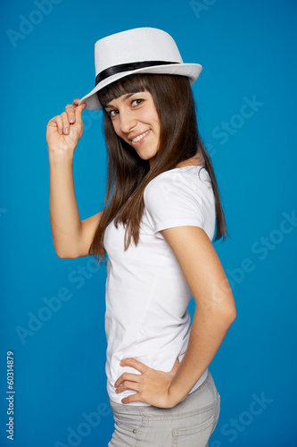 Stylish casual young woman posing with a hat
