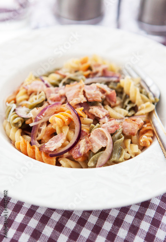 Fusilli pasta with bacon and onion