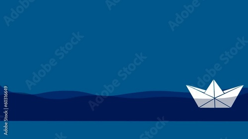 Origami paper boat floats in water