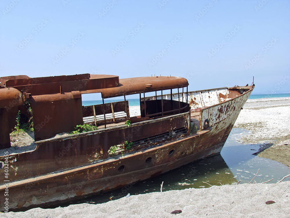 Old, rusty, stranded ship. Abkhazia