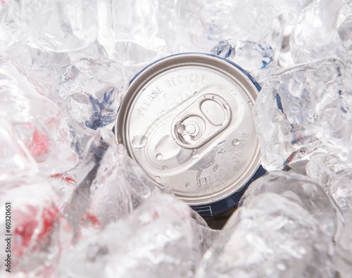 A can of cola drinks with ice cubes