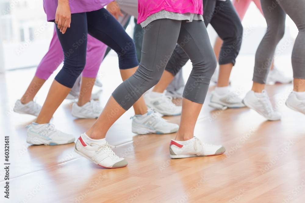 Low section of fitness class doing pilates exercise Low section of fitness class doing pilates exercise