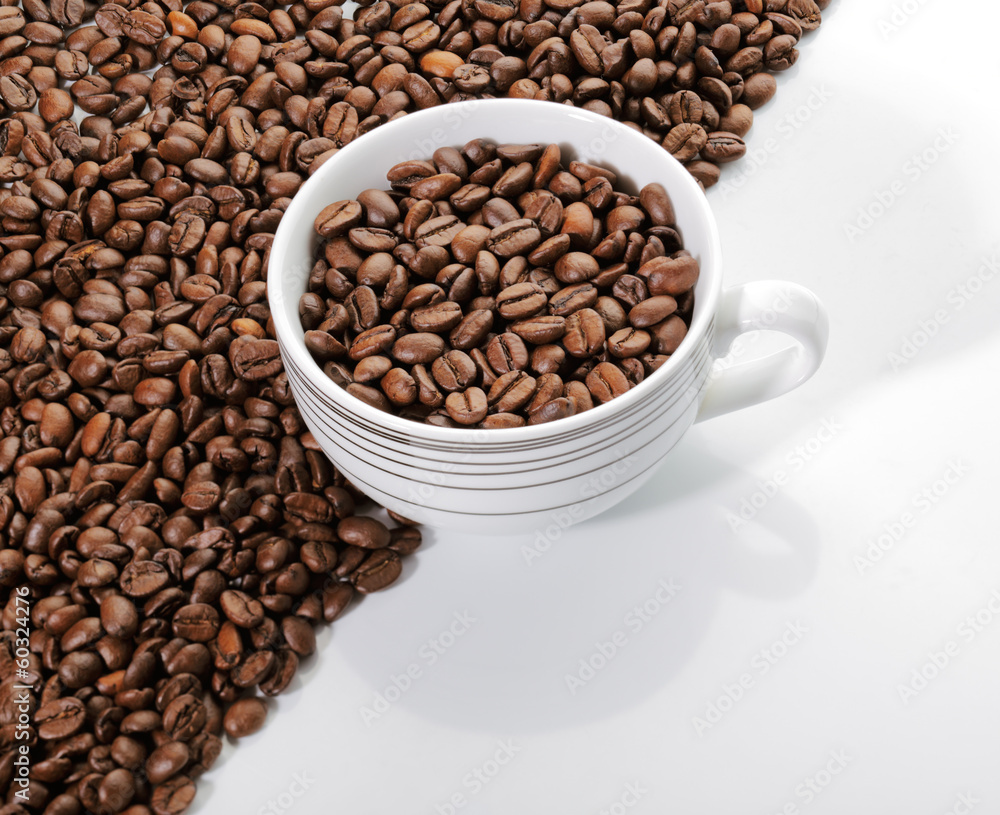 A cup of coffee beans on the edge of diagonal coffee beans shape A cup of coffee beans on the edge of diagonal coffee beans shape