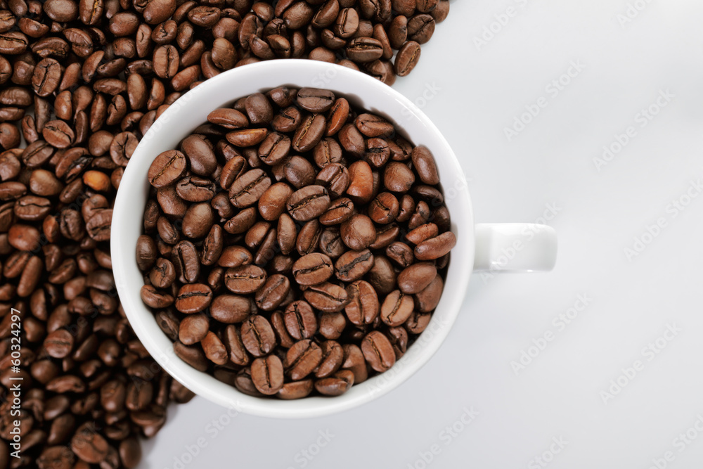 A cup of coffee beans on the edge of diagonal coffee beans shape A cup of coffee beans on the edge of diagonal coffee beans shape