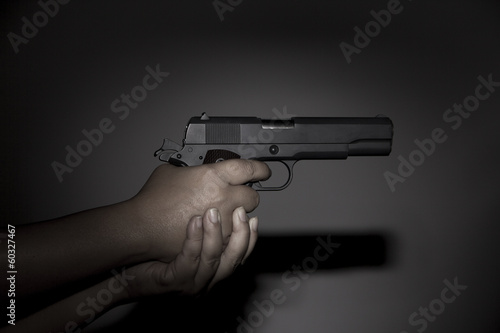 Hand holding gun preparing to fire
