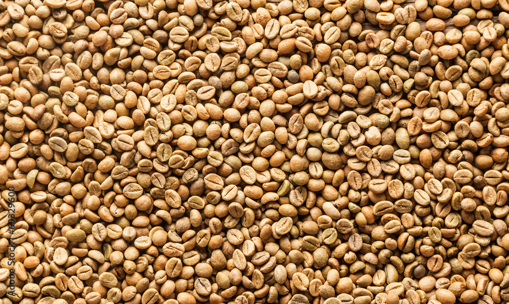 Background texture or fresh raw dried coffee beans Background texture or fresh raw dried coffee beans