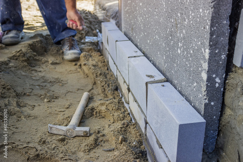 builder worker installing insulation layer photo