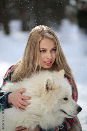 Beautiful young girl with a dog Huskies