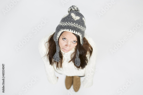 Cute girl in winter clothes looking up and lovely smiling.