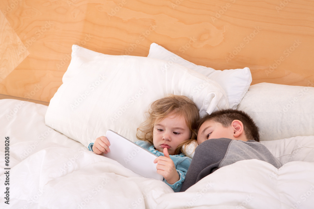 Tired little brother and sister in a warm bed Tired little brother and sister in a warm bed