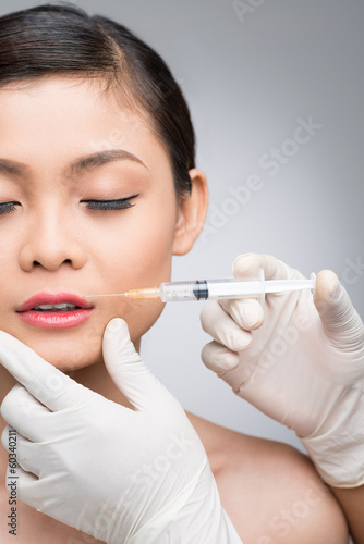 Close-up young woman receives cosmetic injection