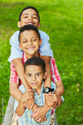 Half-length portrait of three boys-brothers who stand photo